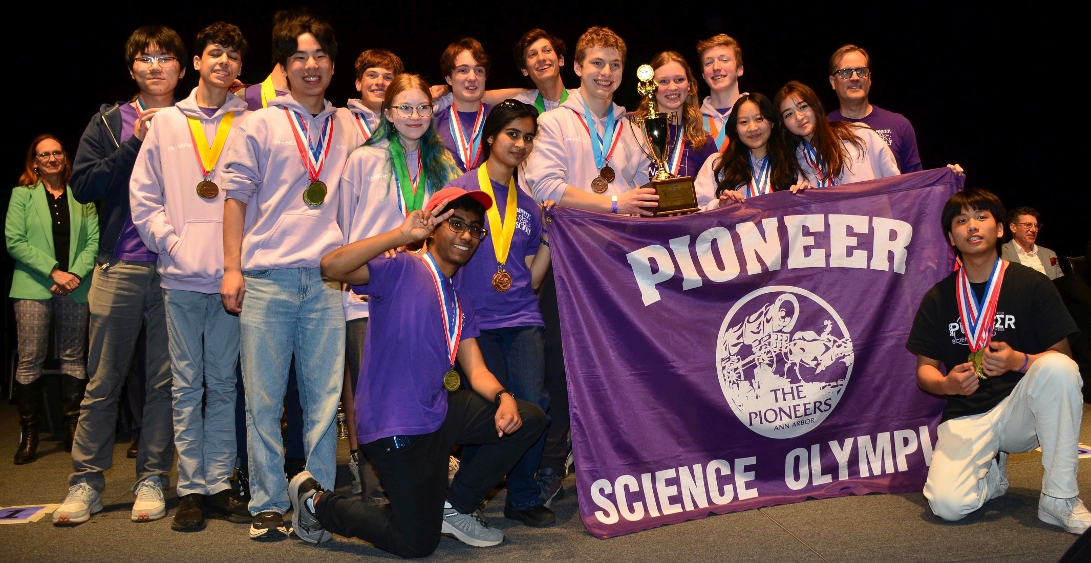 Pioneer Science Olympiad team members standing with awards.